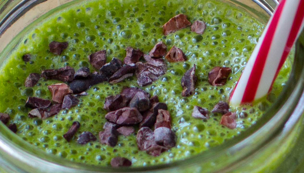 cacao nibs on top of a green smoothie