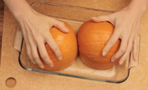 hands on pumpkin halves
